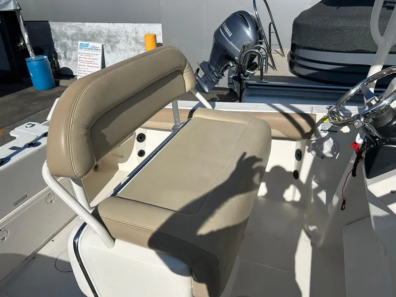 Slide: The Image of 2020 Sailfish 220 WAC boat interior with beige seating and steering wheel. - 12