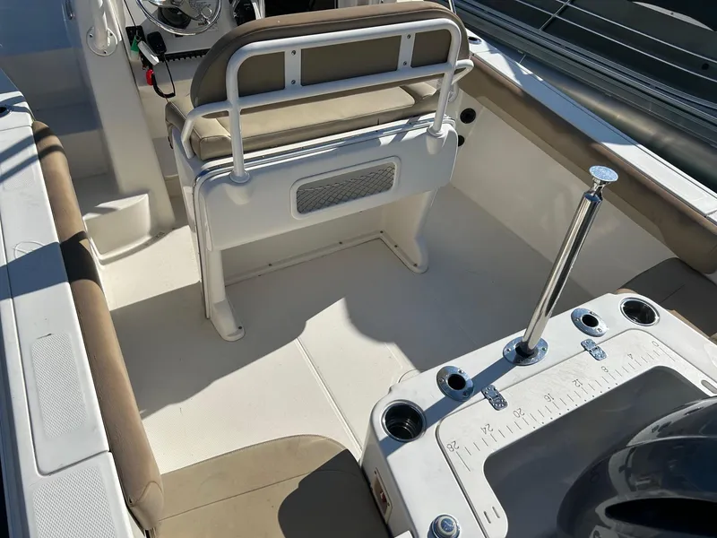 Slide: The Image of 2020 Sailfish 220 WAC boat interior with seating and fishing rod holders. - 13