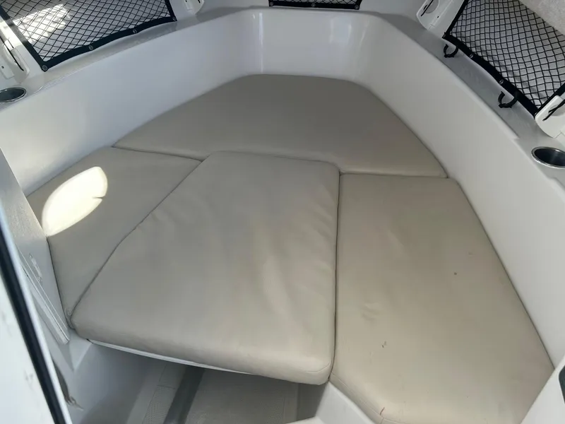 Slide: The Image of 2020 Sailfish 220 WAC cabin interior with cushioned seating and storage nets. - 19