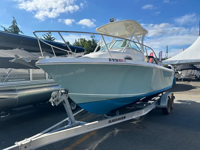 Slide: The Image of 2020 Sailfish 220 WAC boat on Karavan trailer under clear blue sky. - 2