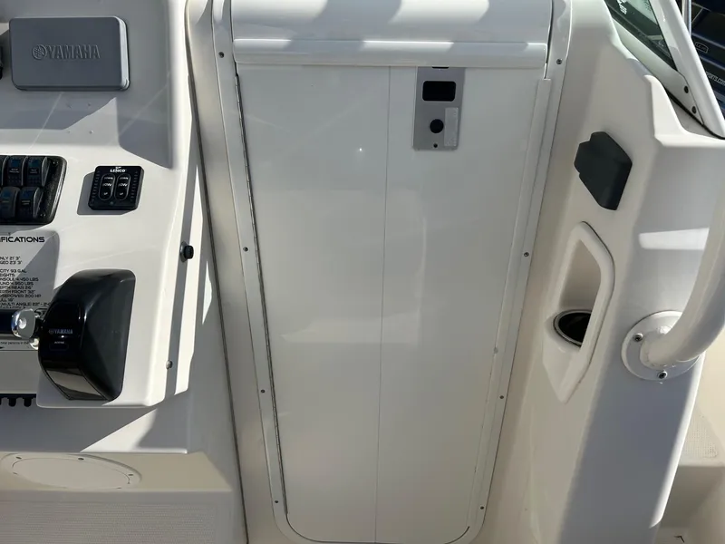 Slide: The Image of 2020 Sailfish 220 WAC boat console with Yamaha controls and storage compartment. - 20