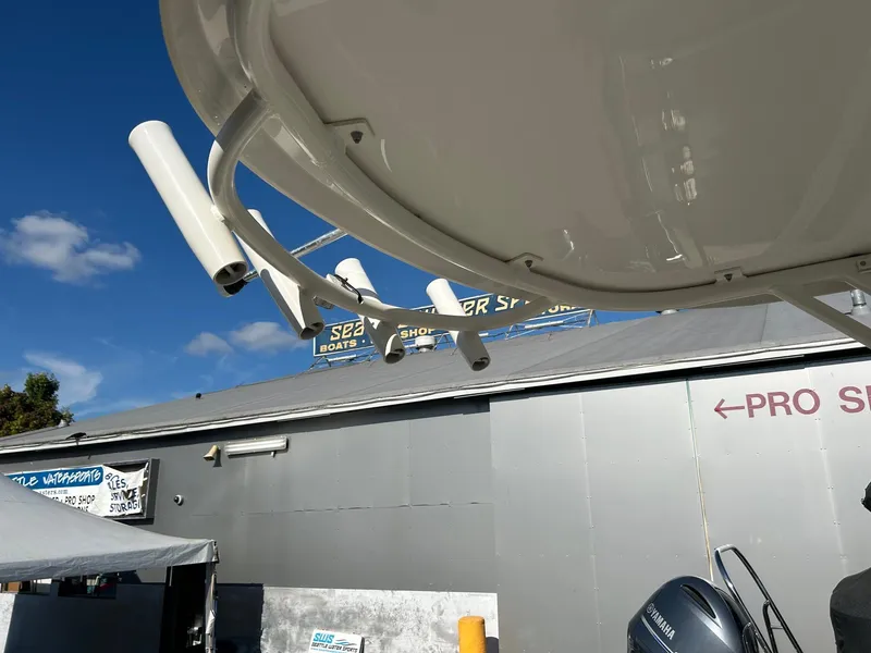 Slide: The Image of 2020 Sailfish 220 WAC boat with rod holders, Yamaha engine, and pro shop sign. - 21