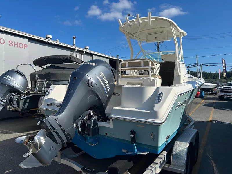 Slide: The Image of 2020 Sailfish 220 WAC boat with Yamaha outboard motor on trailer, parked outdoors. - 5