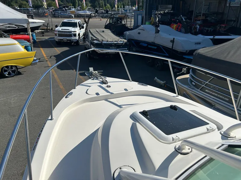 Slide: The Image of 2020 Sailfish 220 WAC boat in a marina, surrounded by various vehicles and boats. - 7