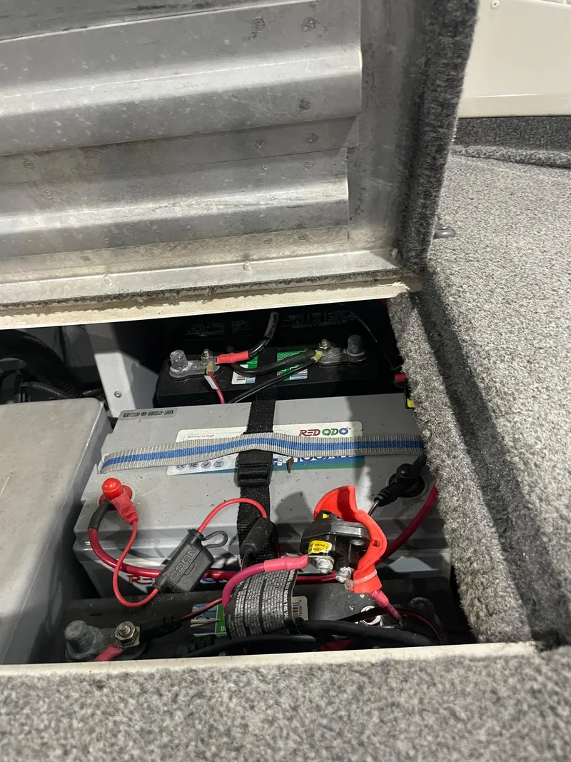 Slide: The Image of Bass Tracker 195 Pro Team XTE 2021 boat battery compartment with wiring and connections. - 11