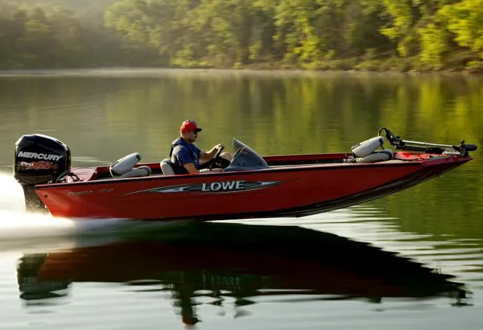 Slide: The Image of Manufacturer Provided Image: 2014 Lowe Stinger 18 HP boat speeding on a calm lake. - 11