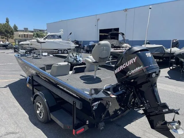 Slide: The Image of 2014 Lowe Stinger 18 HP boat with Mercury 115 engine in a marina setting. - 2