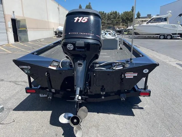 Slide: The Image of 2014 Lowe Stinger 18 HP boat with 115 horsepower engine, parked outdoors. - 3