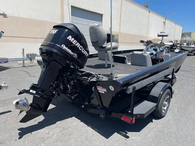 Slide: The Image of 2014 Lowe Stinger 18 HP boat with Mercury 115 outboard motor, parked on a trailer. - 4