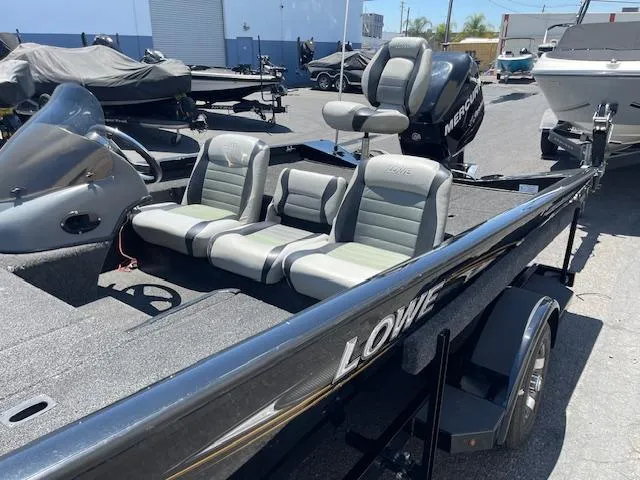 Slide: The Image of 2014 Lowe Stinger 18 HP boat with seating and Mercury outboard motor. - 5