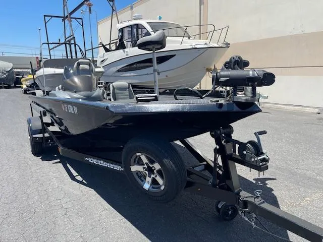 Slide: The Image of 2014 Lowe Stinger 18 HP boat on trailer, parked outdoors. - 7