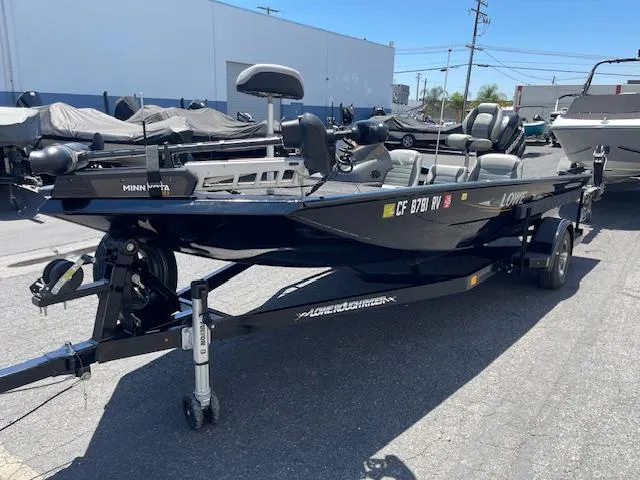 Slide: The Image of 2014 Lowe Stinger 18 HP boat on trailer, parked outdoors. - 9