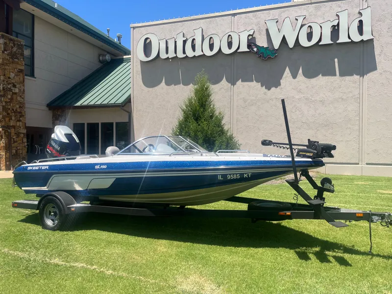 The Image of 2013 Skeeter SL190 boat displayed outside Outdoor World on a sunny day. - 1