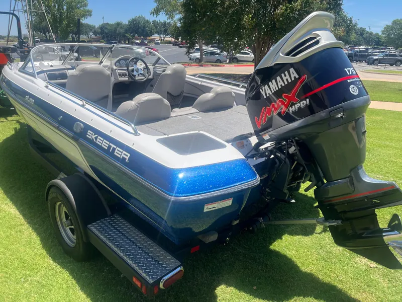 Slide: The Image of 2013 Skeeter SL190 boat with Yamaha VMAX engine on grassy area. - 6