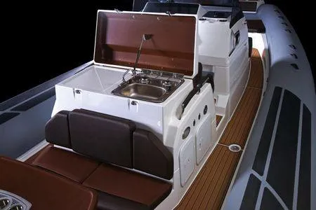 Slide: The Image of 2026 Brig Eagle 10 boat interior with kitchenette and seating, featuring modern design and wood accents. - 12