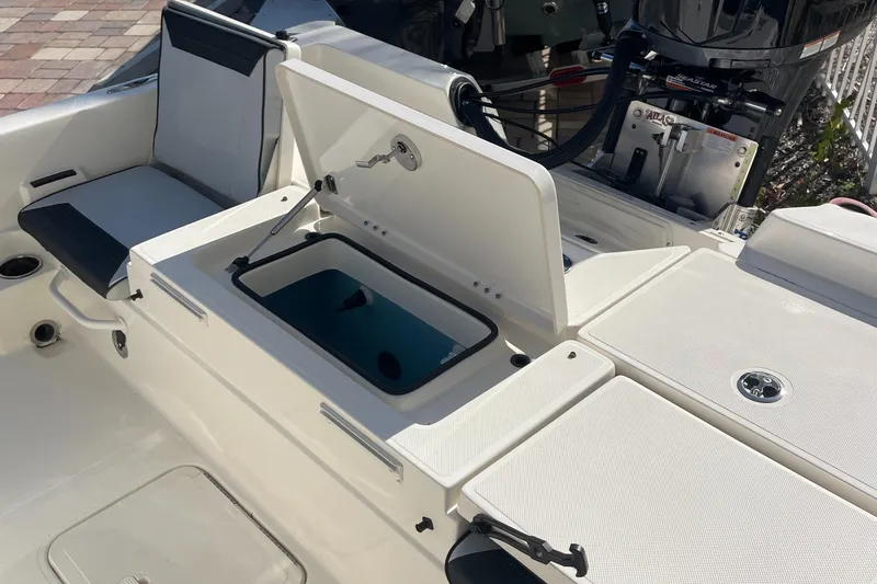 Slide: The Image of 2026 Skeeter SX 230 boat interior with open storage compartment and seating. - 4