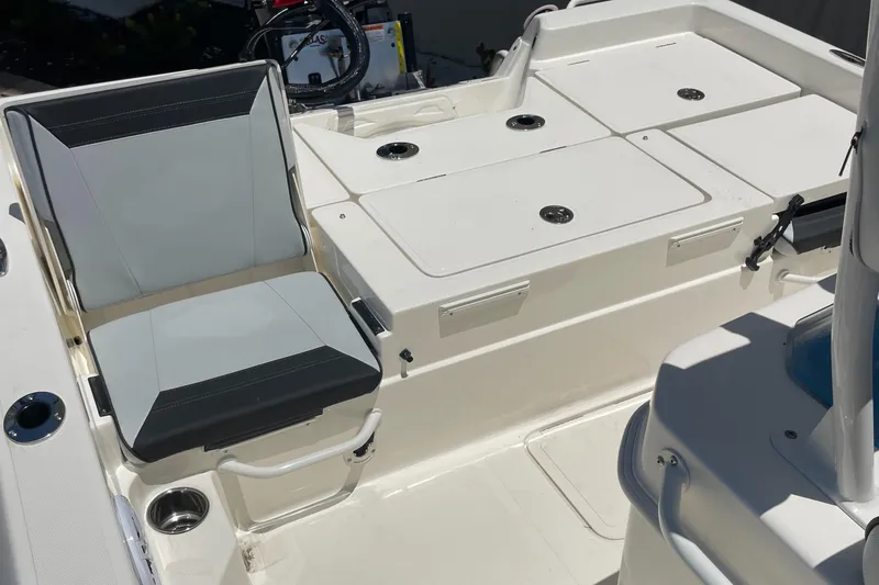 Slide: The Image of 2026 Skeeter SX 230 boat interior with cushioned seating and storage compartments. - 5