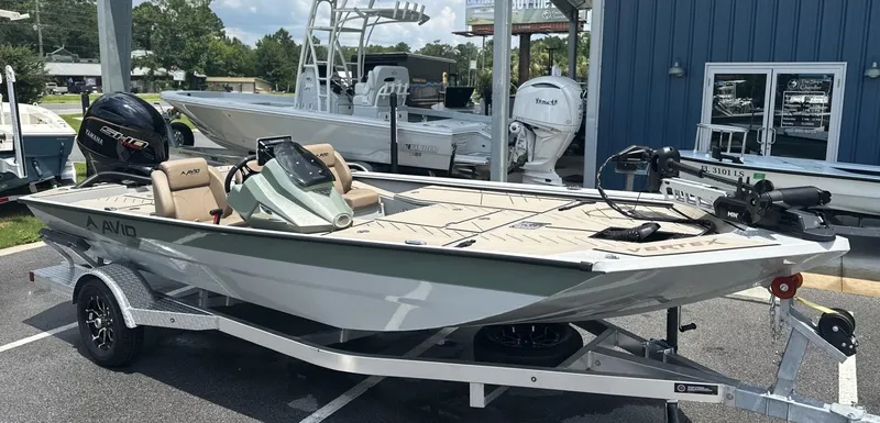 Slide: The Image of 2025 Avid 18 Vertex boat on trailer, featuring Yamaha engine, parked outdoors. - 0
