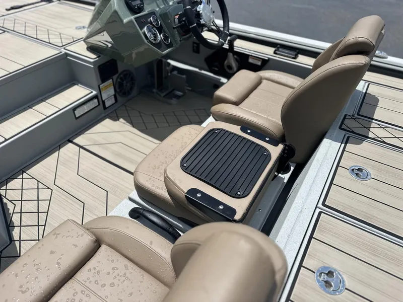 Slide: The Image of Interior of 2025 Avid 18 Vertex boat with beige seats and modern dashboard. - 10
