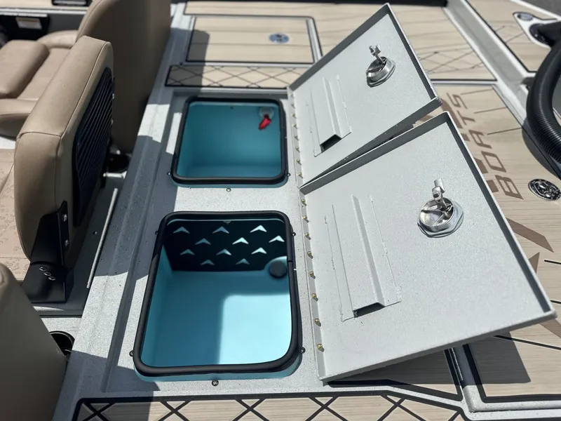 Slide: The Image of Open storage compartments on a 2025 Avid 18 Vertex boat deck. - 11