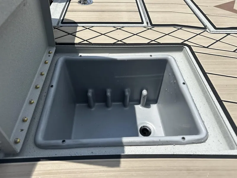 Slide: The Image of Open storage compartment on 2025 Avid 18 Vertex boat deck. - 12