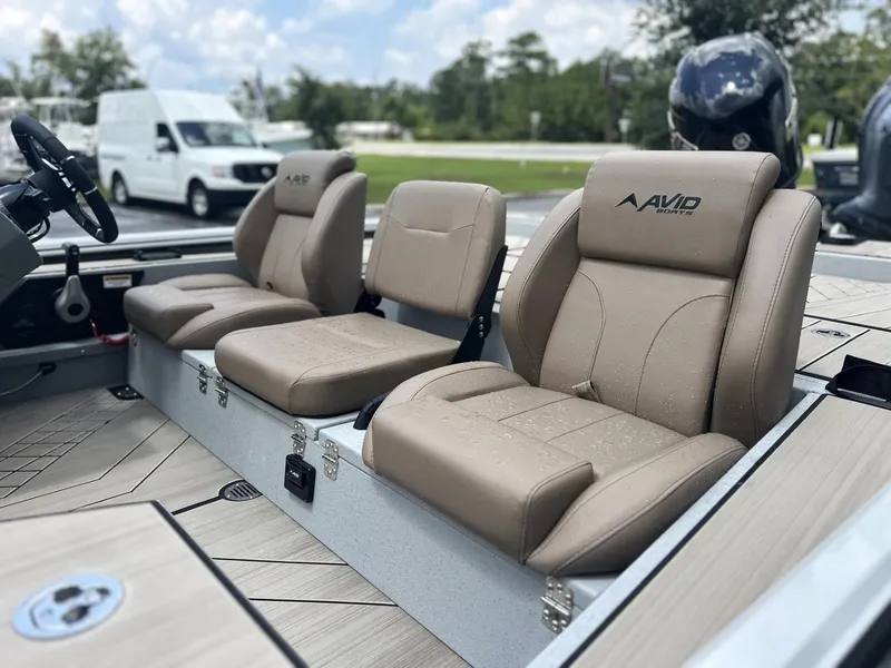 Slide: The Image of 2025 Avid 18 Vertex boat interior with beige seats and modern design. - 14