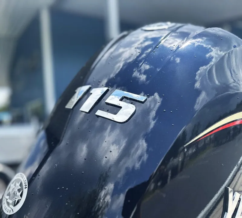 Slide: The Image of Close-up of a 2025 Avid 18 Vertex boat engine with "115" marking. - 24