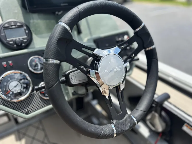Slide: The Image of Steering wheel of 2025 Avid 18 Vertex boat with dashboard instruments. - 3