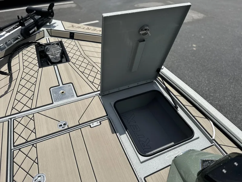 Slide: The Image of Avid 18 Vertex 2025 boat deck with open storage compartment and sleek design. - 6