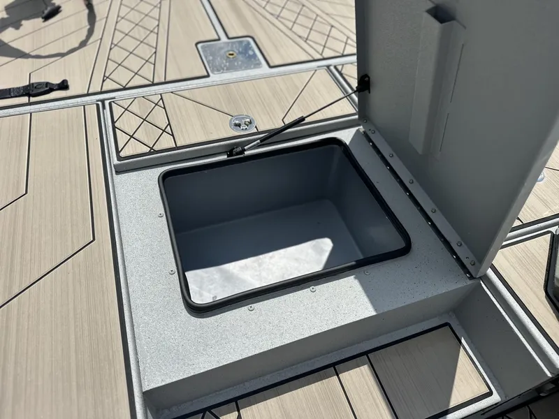 Slide: The Image of Open storage compartment on 2025 Avid 18 Vertex boat deck. - 7