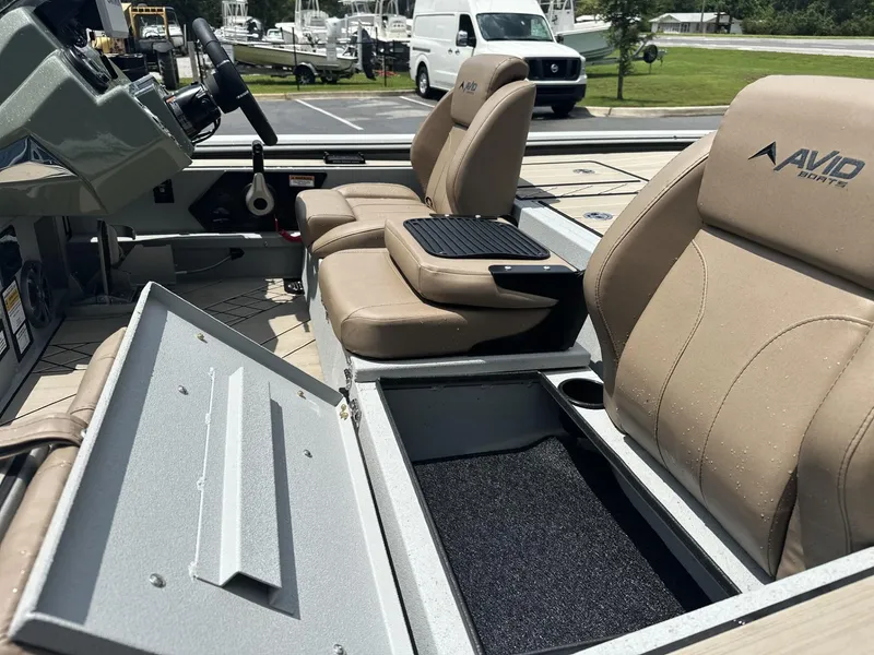 Slide: The Image of Interior of 2025 Avid 18 Vertex boat with tan seats and storage compartment. - 8
