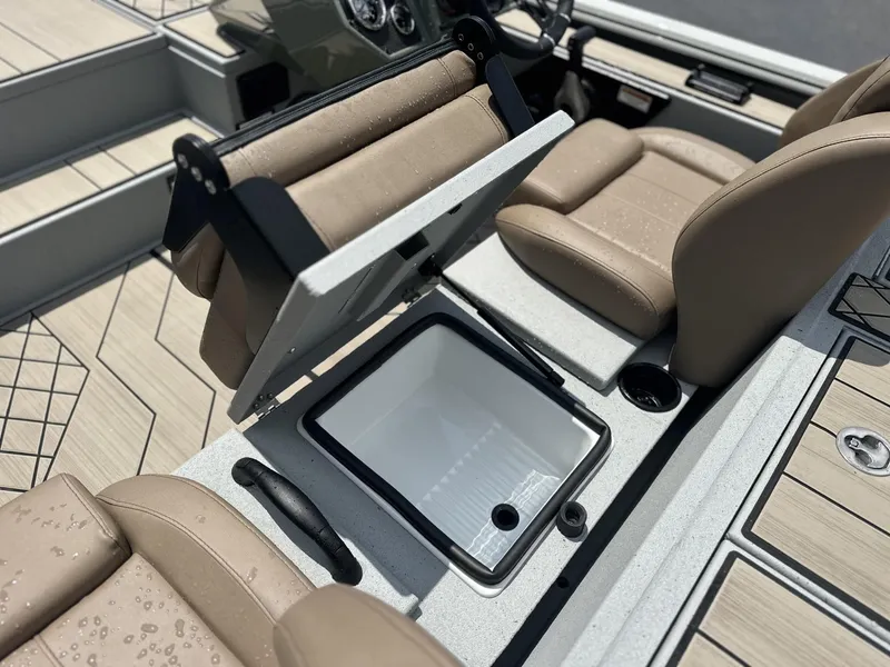Slide: The Image of Avid 18 Vertex 2025 boat interior with open storage compartment and beige seating. - 9