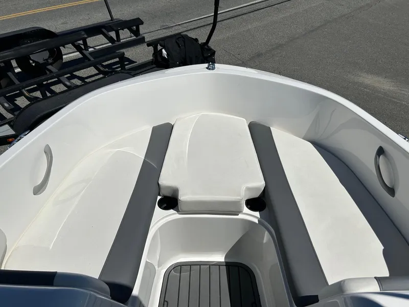 Slide: The Image of 2020 Bayliner Element E18 boat interior with white seating and cup holders. - 11