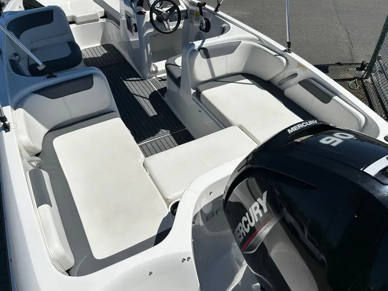 Slide: The Image of 2020 Bayliner Element E18 boat interior with Mercury 90 engine, featuring spacious seating and steering wheel. - 13