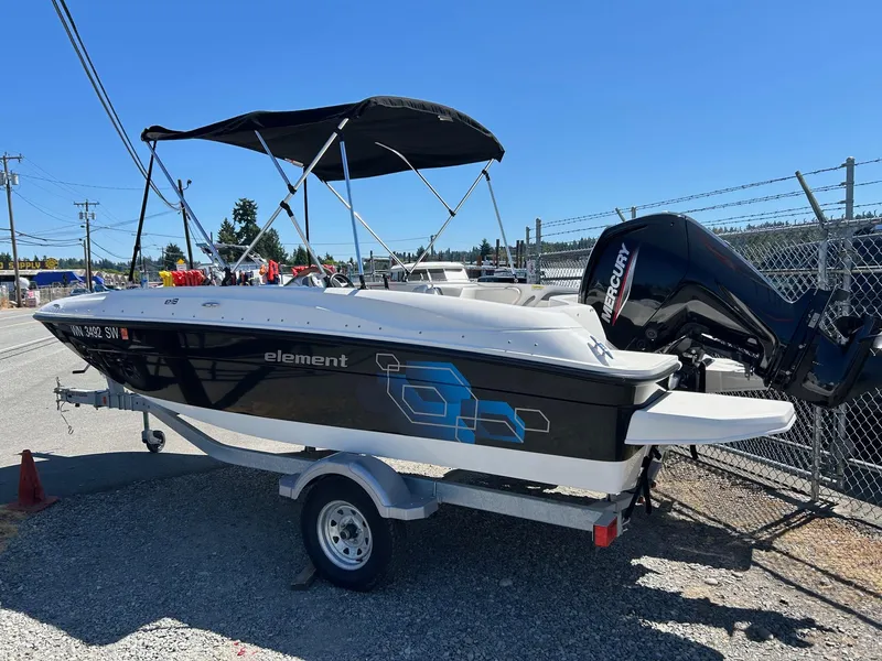 Slide: The Image of 2020 Bayliner Element E18 boat on trailer with Mercury outboard motor. - 2