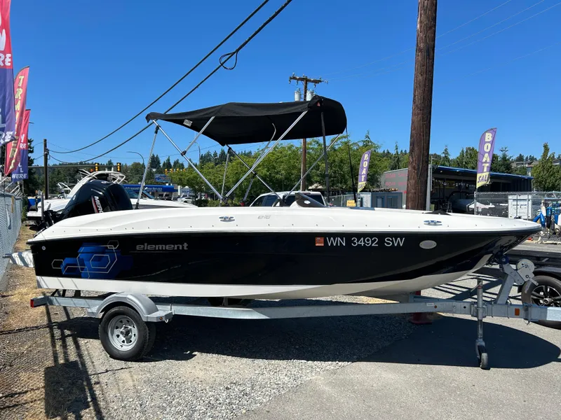 Slide: The Image of 2020 Bayliner Element E18 boat on trailer, black and white design, outdoor display. - 3