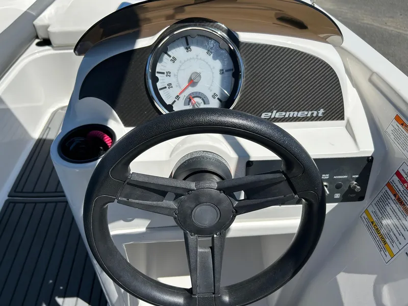 Slide: The Image of 2020 Bayliner Element E18 dashboard with steering wheel and speedometer. - 5