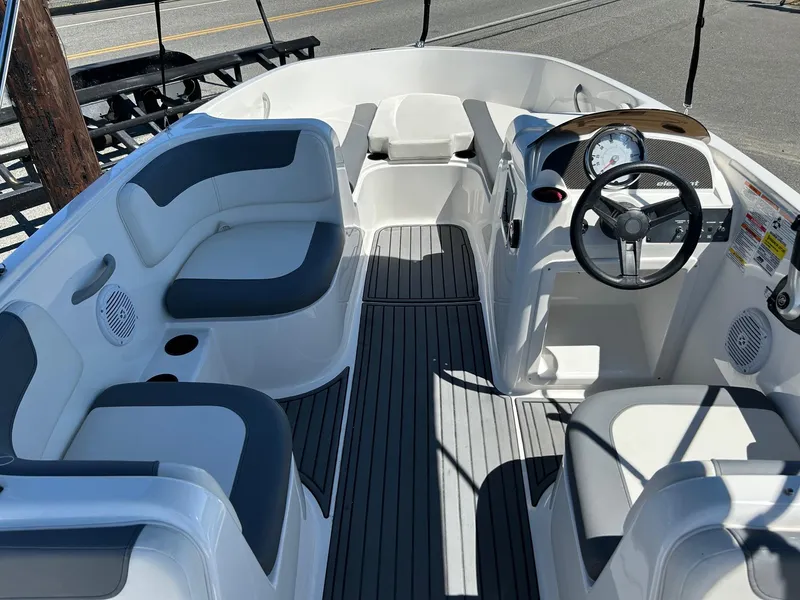 Slide: The Image of 2020 Bayliner Element E18 boat interior with seating and steering wheel. - 7