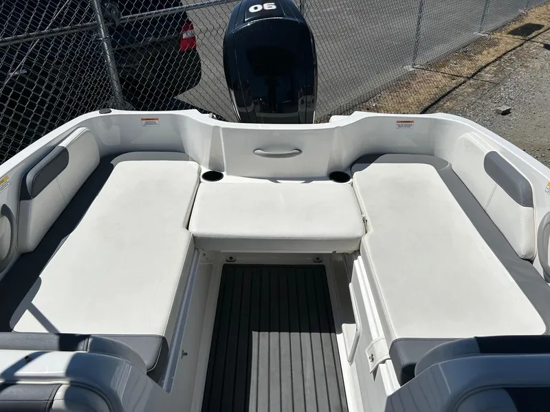Slide: The Image of 2020 Bayliner Element E18 boat interior with cushioned seating and outboard motor. - 8