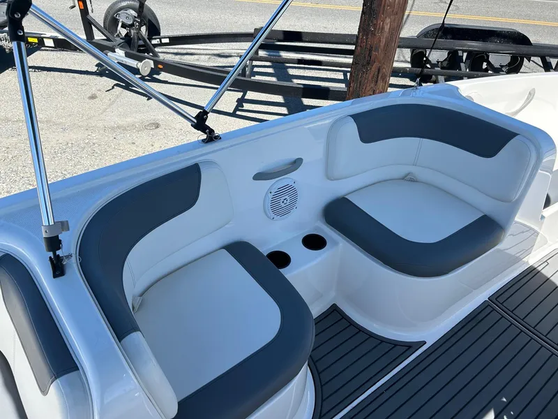 Slide: The Image of 2020 Bayliner Element E18 boat interior with cushioned seating and cup holders. - 9