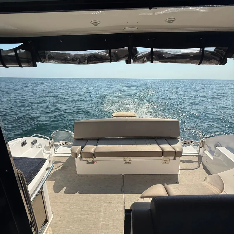 Slide: The Image of 2015 Regal 46 Sport Coupe boat interior with ocean view, featuring comfortable seating. - 10