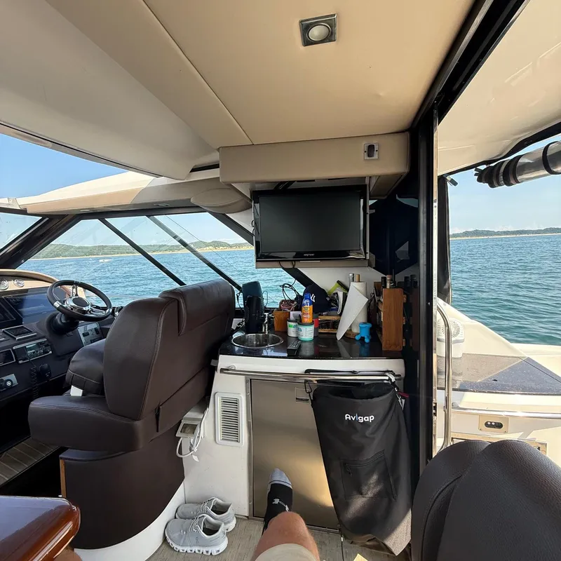 Slide: The Image of Interior of a 2015 Regal 46 Sport Coupe yacht with ocean view. - 11