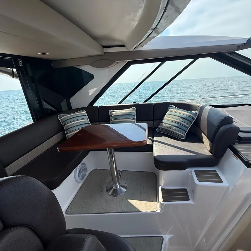 Slide: The Image of Interior of 2015 Regal 46 Sport Coupe yacht with seating and ocean view. - 13