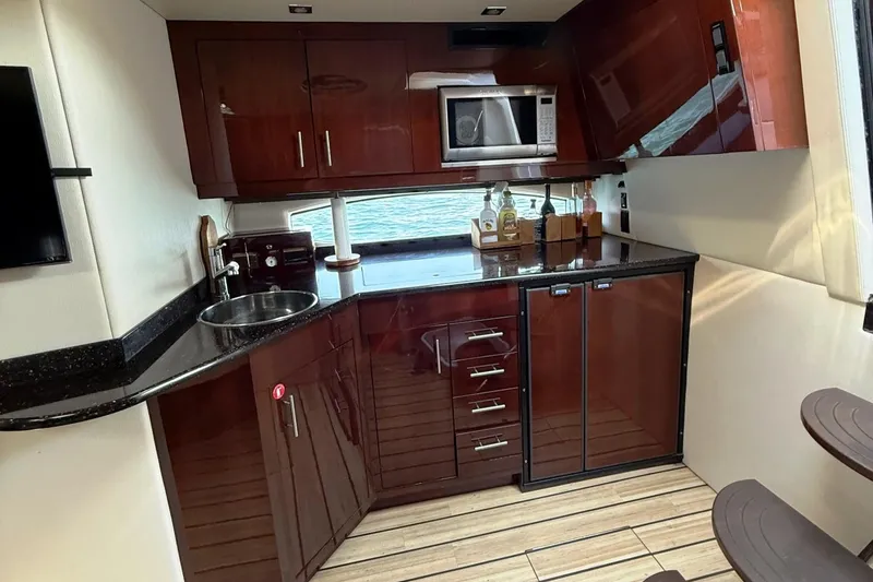 Slide: The Image of Luxurious kitchen interior of 2015 Regal 46 Sport Coupe yacht with modern amenities. - 17