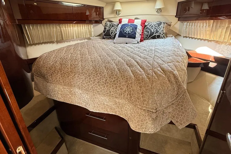 Slide: The Image of Luxurious cabin interior of 2015 Regal 46 Sport Coupe with cozy bedding and nautical decor. - 19