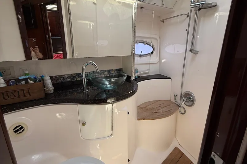Slide: The Image of Luxurious bathroom in 2015 Regal 46 Sport Coupe yacht with modern fixtures and glass sink. - 22