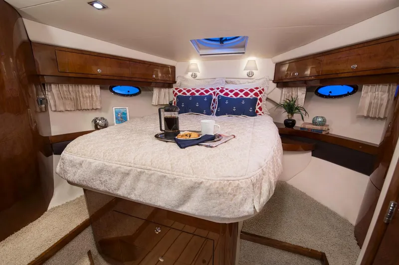Slide: The Image of Manufacturer Provided Image: Luxurious bedroom interior of 2015 Regal 46 Sport Coupe yacht with cozy bedding and wooden accents. - 35