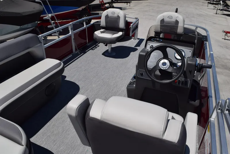 Slide: The Image of 2026 Sun Tracker Bass Buggy 18 DLX pontoon boat interior with steering console and seating. - 4