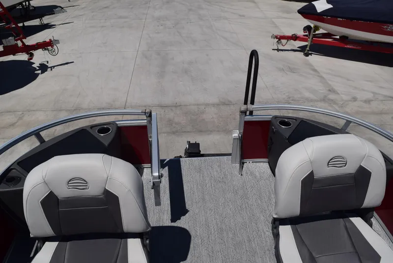 Slide: The Image of 2026 Sun Tracker Bass Buggy 18 DLX pontoon boat interior with two seats and cup holders. - 8