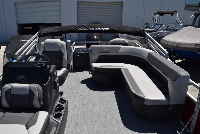 Slide: The Image of 2026 Sun Tracker Bass Buggy 18 DLX pontoon boat interior with seating and helm. - 9